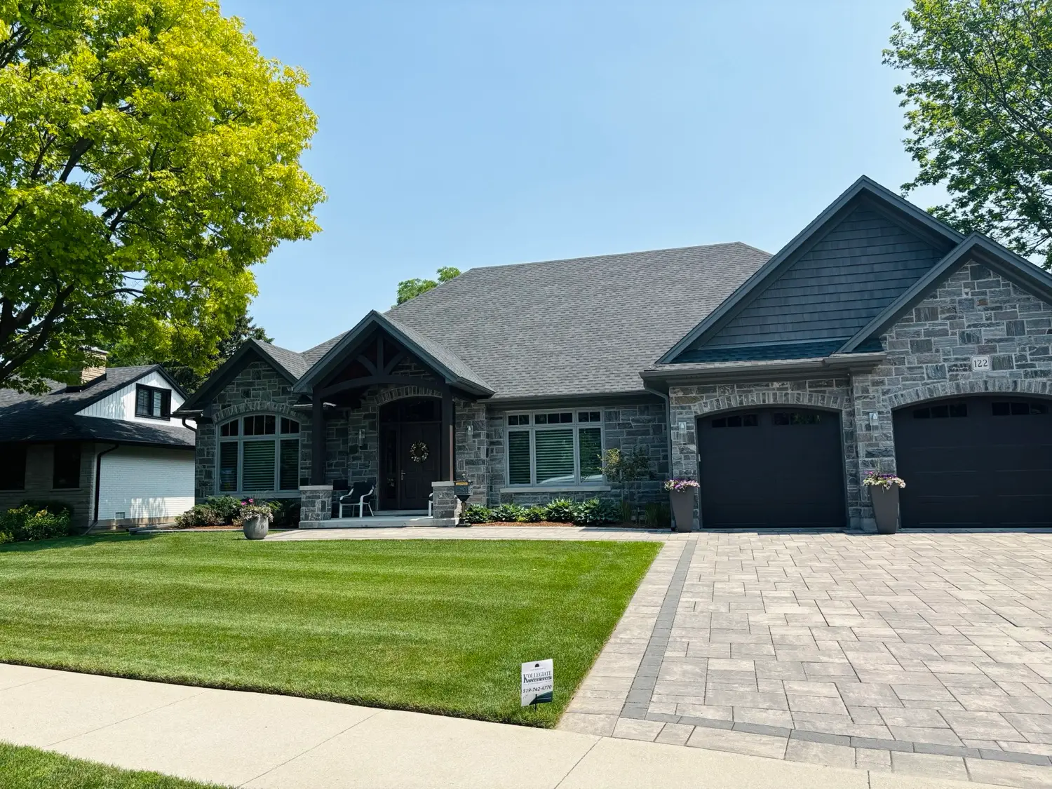 Healthy green lawn in front of a stone house