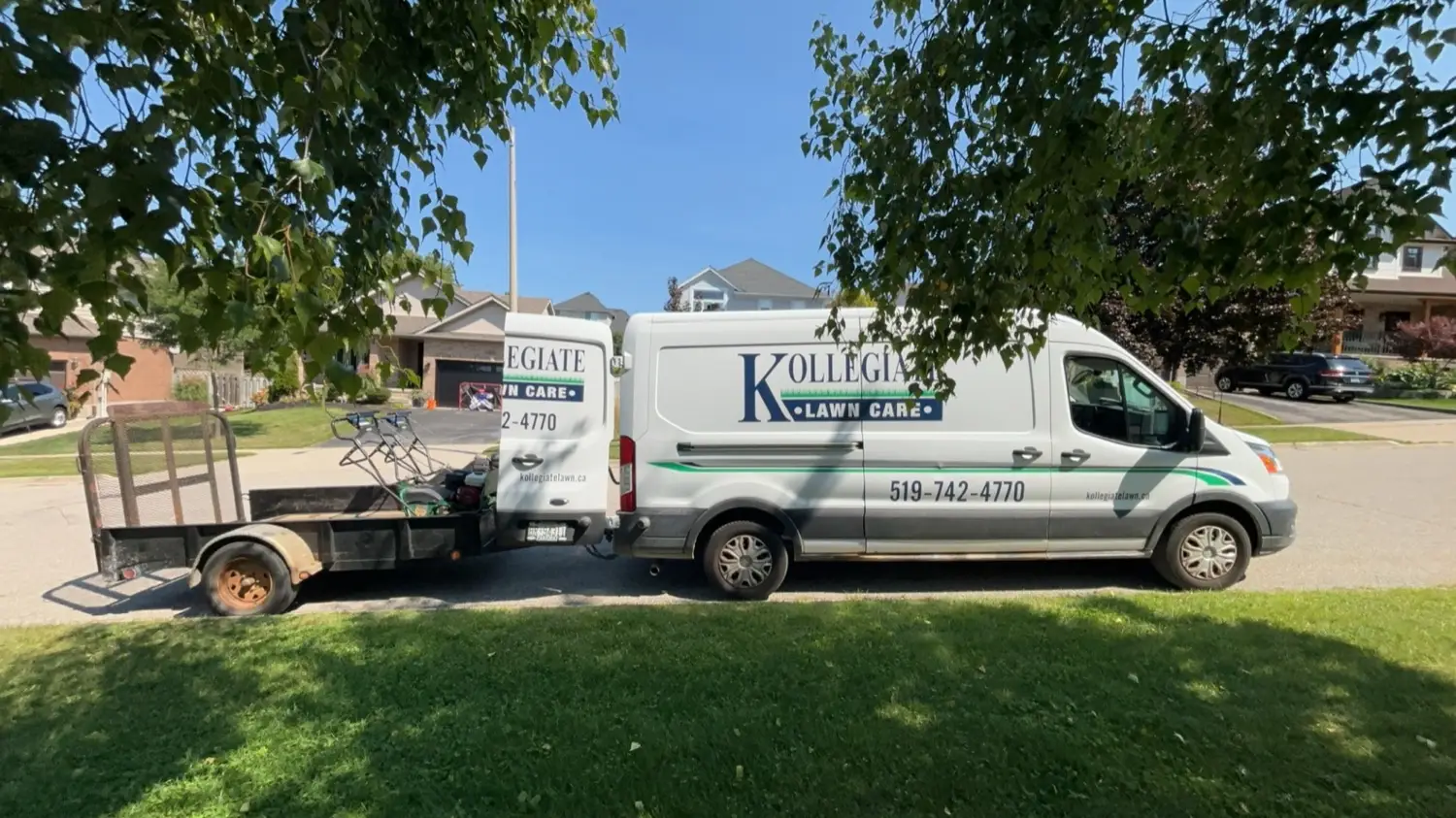 Kollegiate Lawn Care van and trailer at a job site